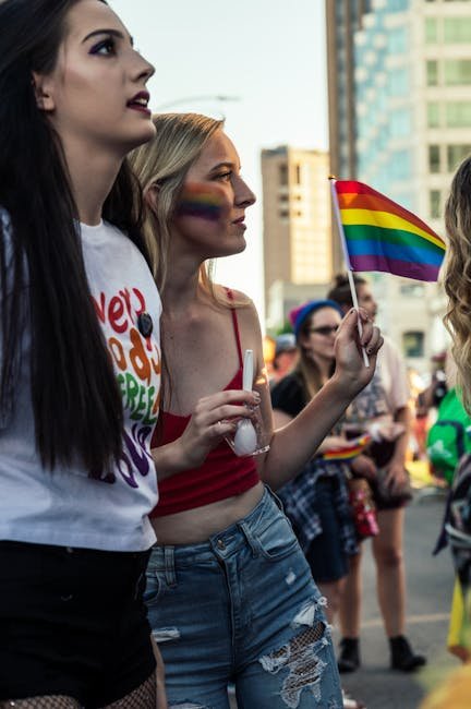 LGBTQ pride parade with colorful flags and joyful participants celebrating diversity.